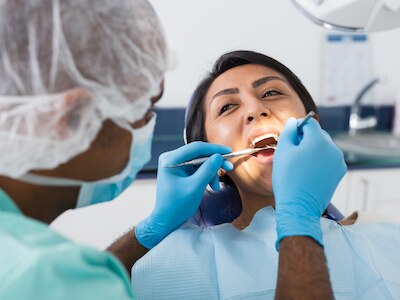 A dentist examining a patient's teeth.