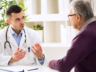 A doctor talks to a senior patient.