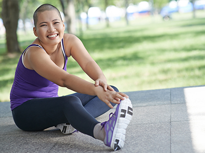 A woman exercising outdoors.