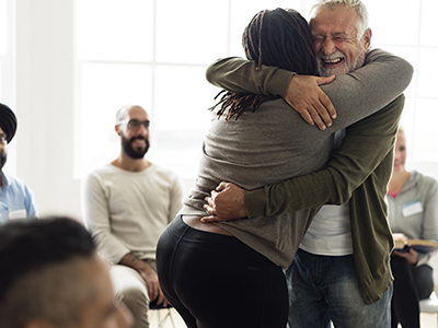 Man and woman standing and hugging each other