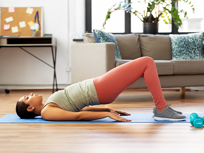 Person doing pelvic lift abdominal exercise at home.