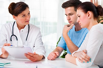 Doctor talking to a couple.