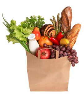 Photo of a bag of groceries containing fruit, vegetables, milk, and bread.
