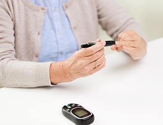 Woman checking blood glucose.