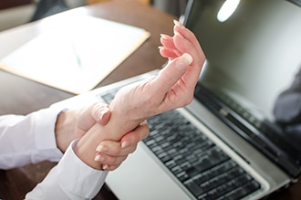 Woman holding her painful wrist.