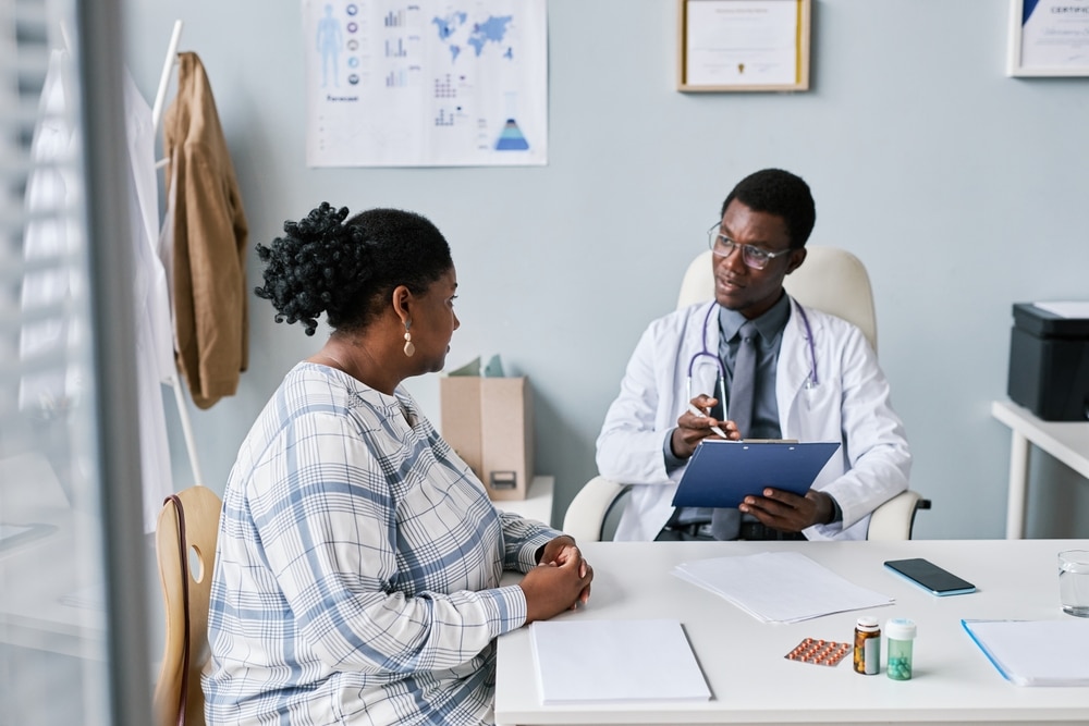 A woman talking with her doctor in a medical office.