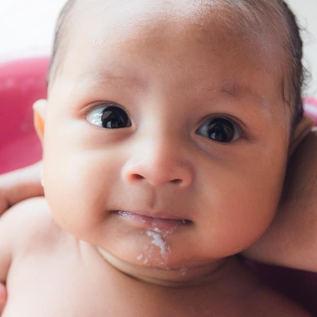 Infant with spit-up on chin.