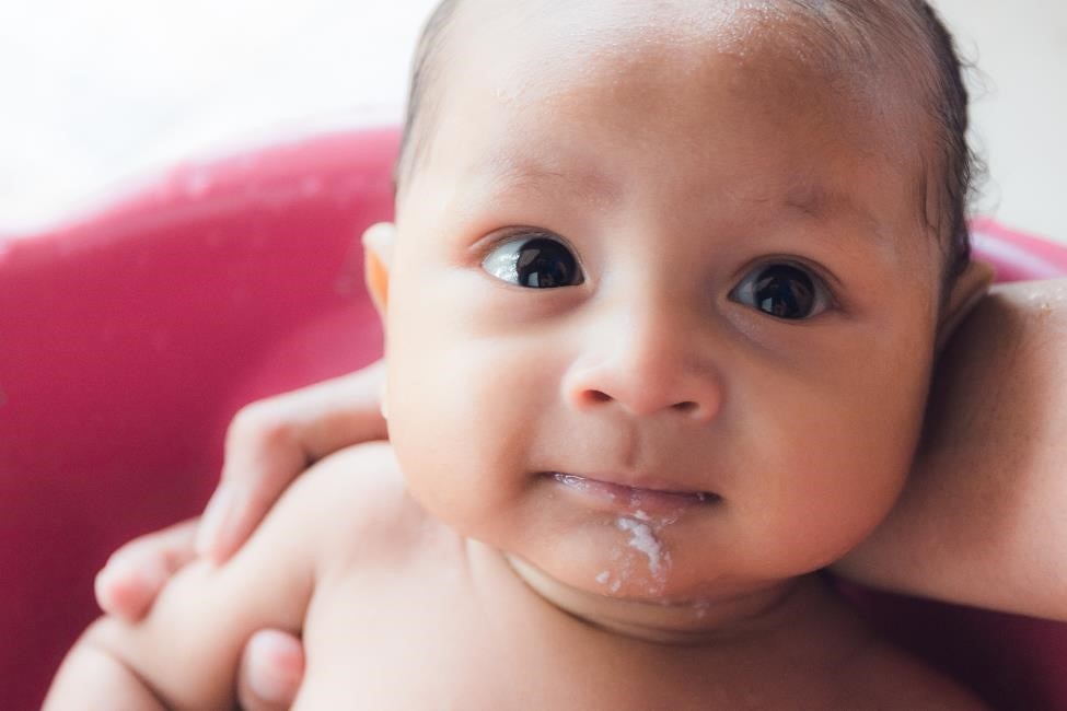 Infant with spit-up on chin.