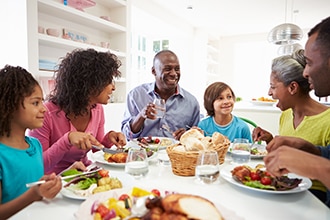 A group of people eating a meal at a table.