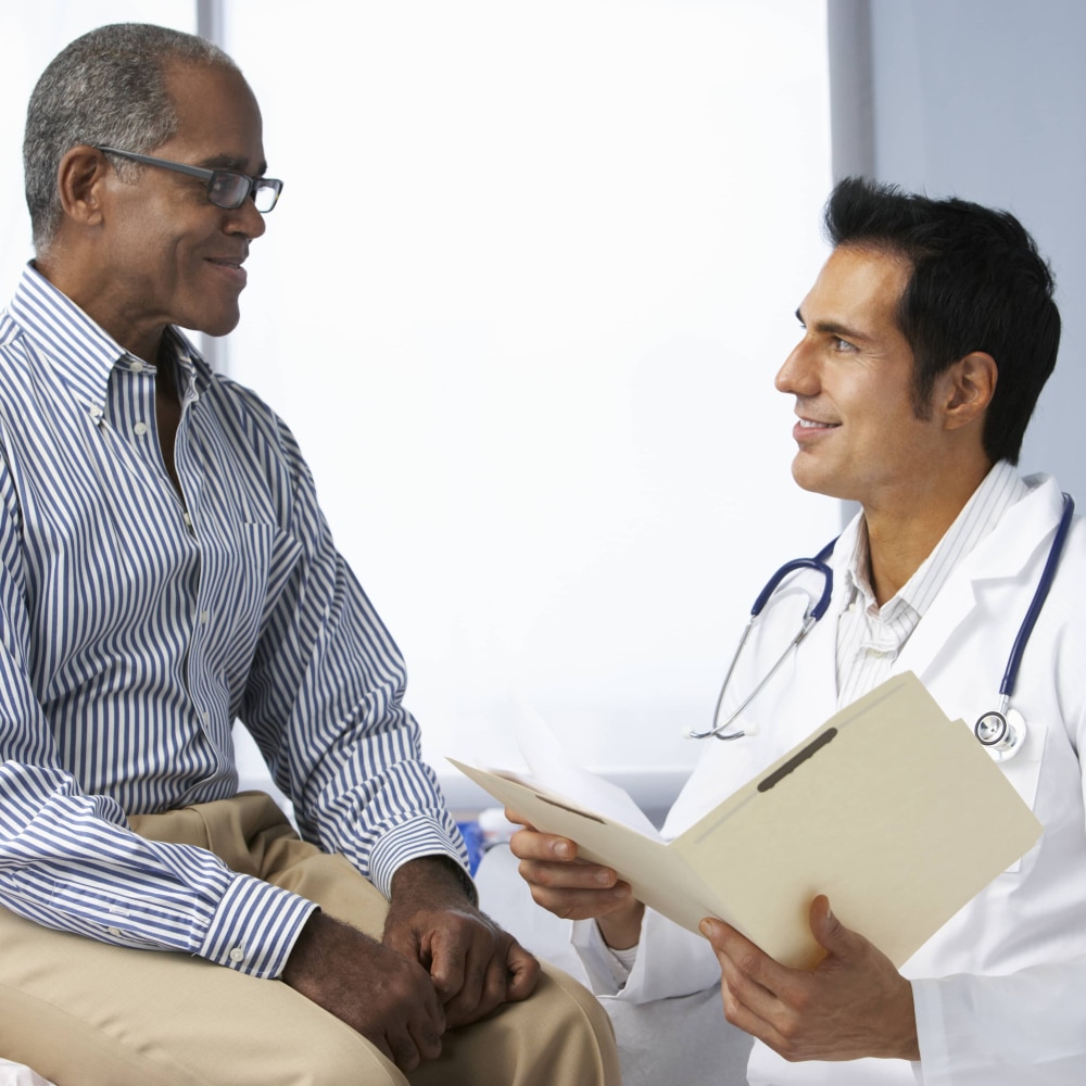 Patient talking with a doctor in a doctor’s office.