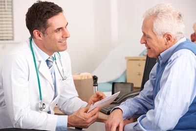 A doctor talking with a patient in his office.