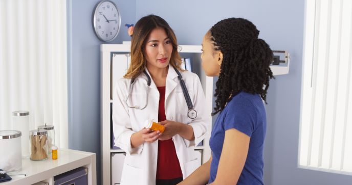 Doctor talking with a patient about medicine.