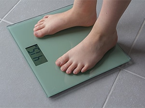 A person standing on a scale.