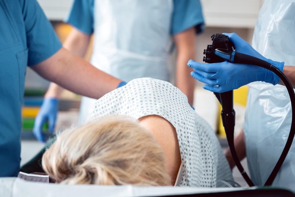 Health care professionals performing a colonoscopy.