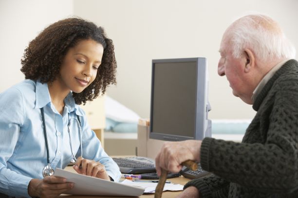 Doctor talking with an older adult patient.