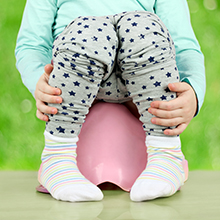 child sitting on a training toilet