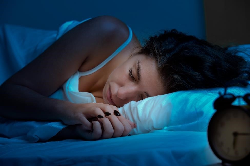 Young woman resting in bed.