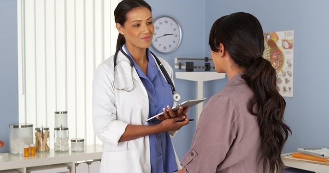 A health care professional speaks with a patient.