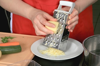 Person grating potatoes.