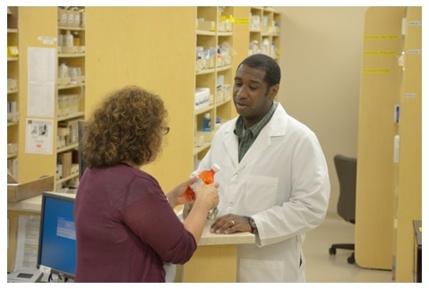Woman talking with pharmacist.