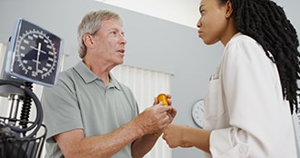 Health care professional prescribes medicine to patient.