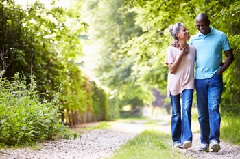 A photo of a woman and a man being active by walking.