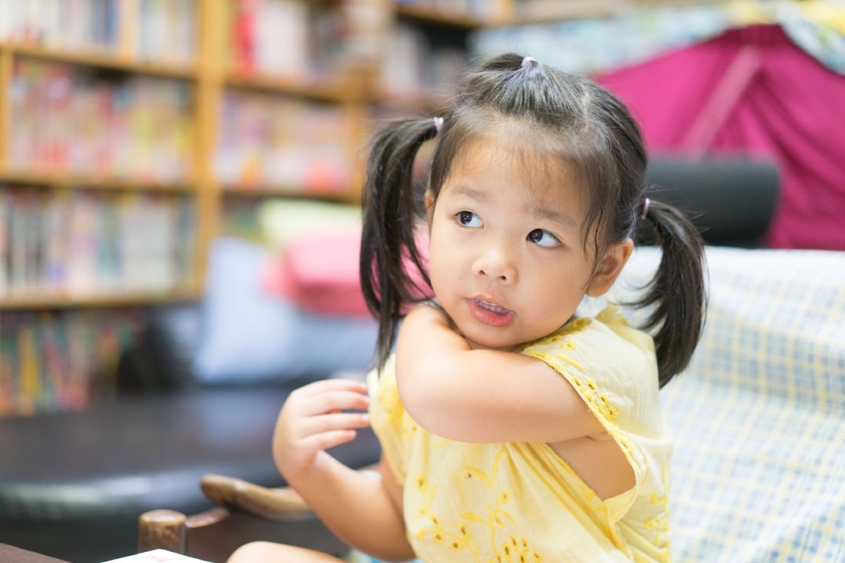 Young child scratching itchy skin