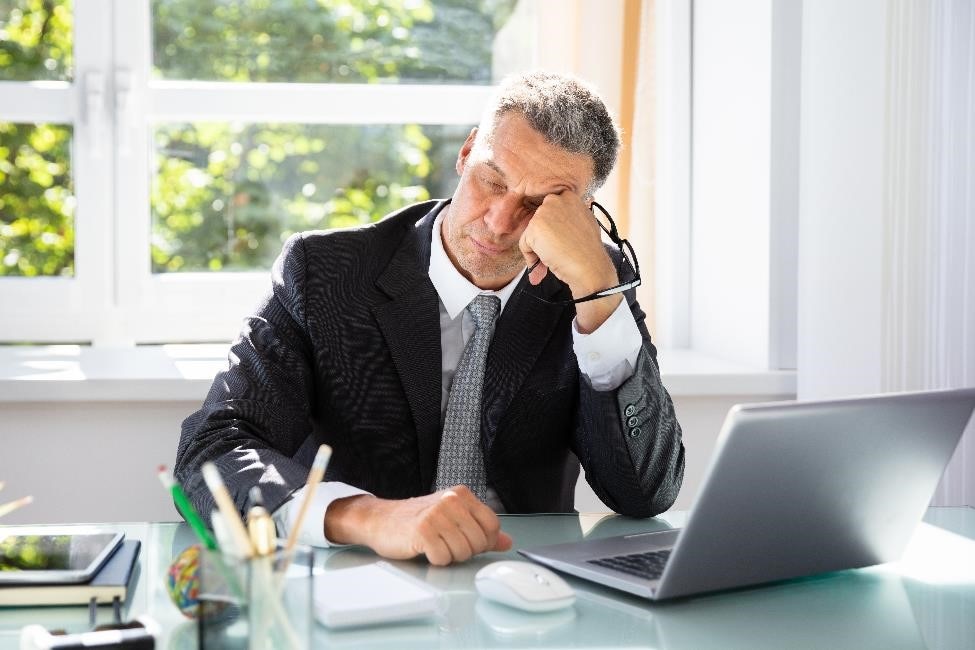 Man falling asleep at his desk.