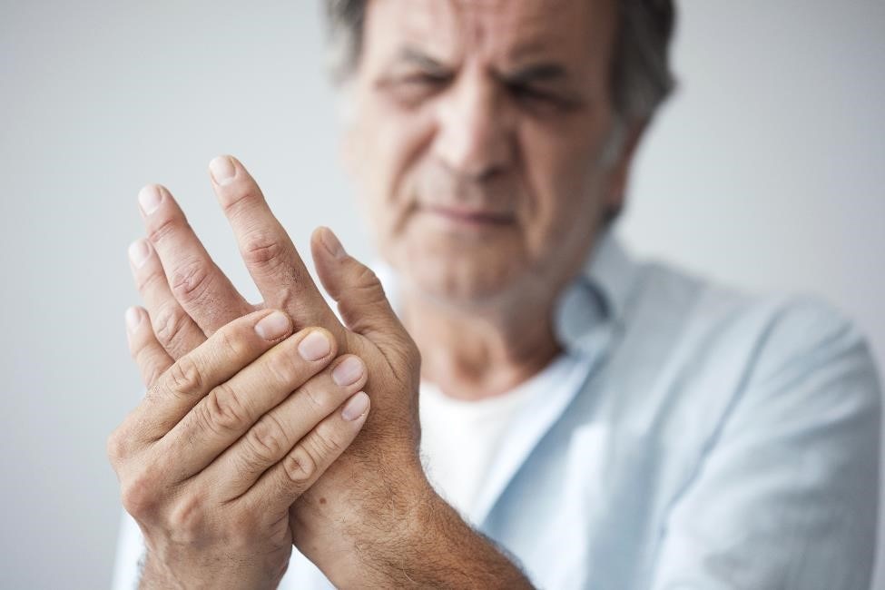 Older man with arthritis in his hand.