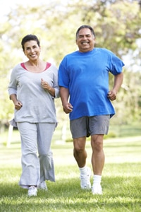 An overweight couple walking outdoors.