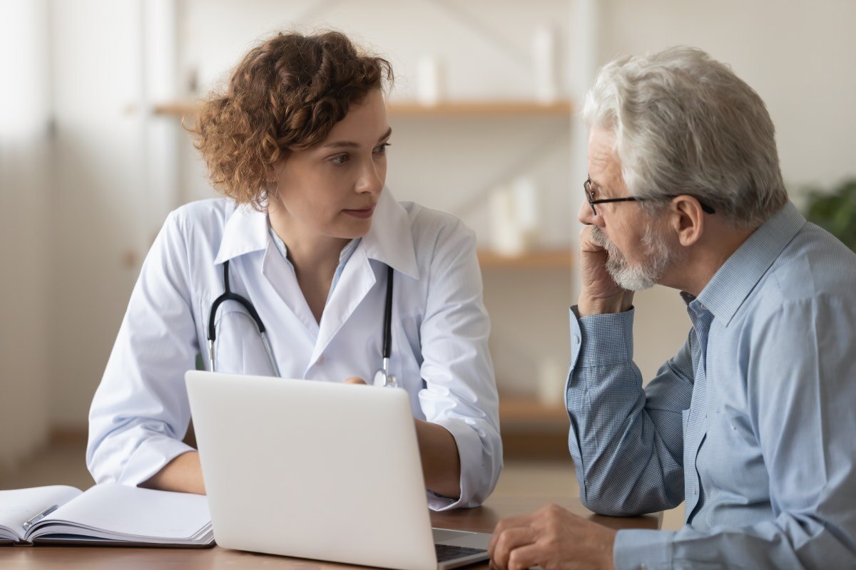 A health care professional talking with a patient.