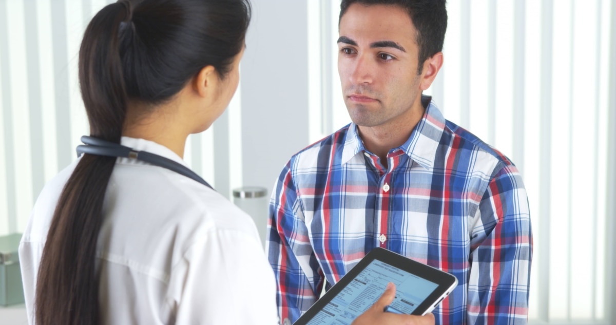 Female doctor talking with a male patient.