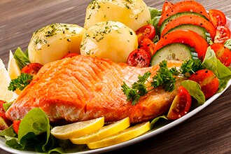 Grilled fish and vegetables on a plate.