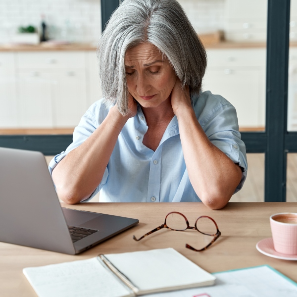 Tired woman sitting in front of a laptop.