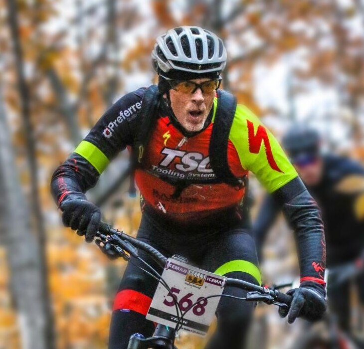 Photo of Jeff mountain biking in a race.