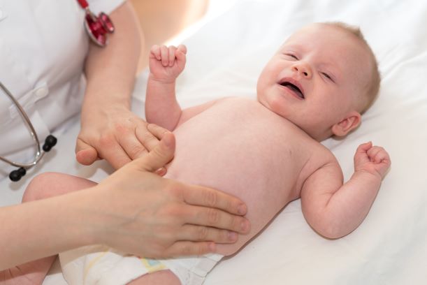 Newborn infant being examined by a health care professional.