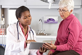 Health care professional shares test results with woman.