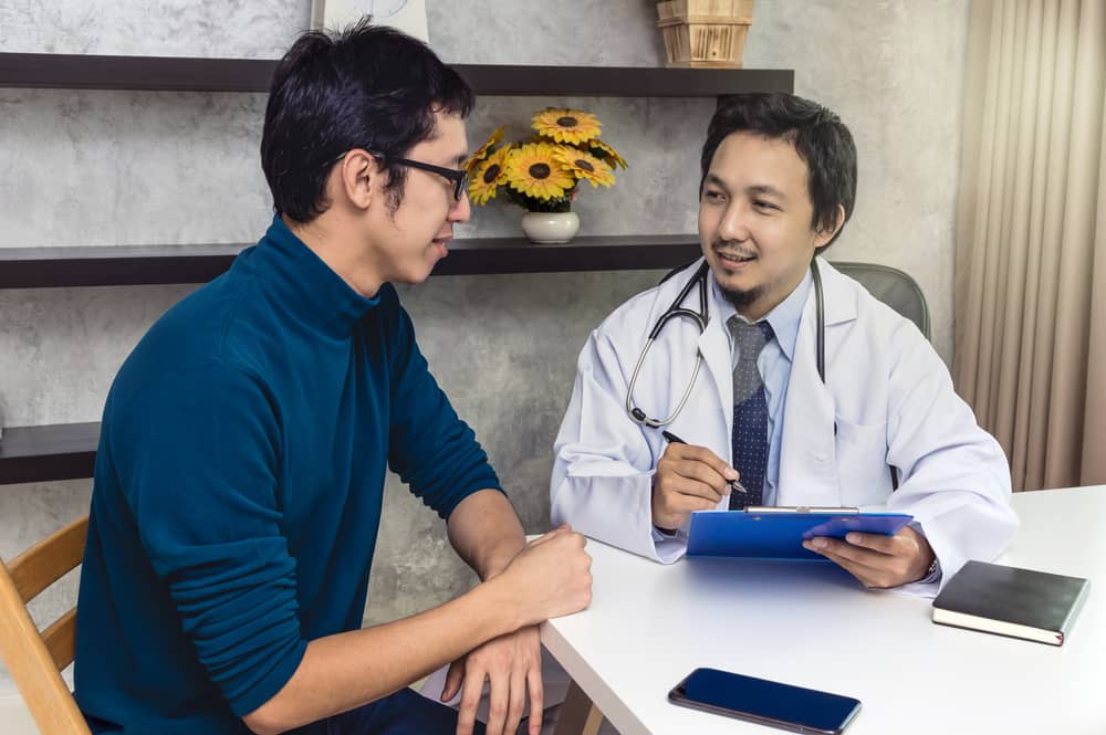 A health care professional speaks with a patient.