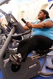 A woman exercising on a recumbent bike