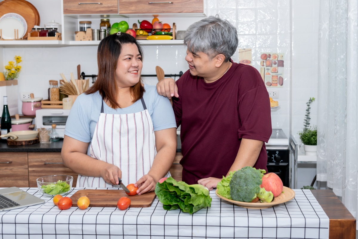 Couple cooking a meal in the kitchen.