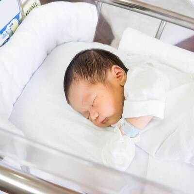 A baby in a hospital bassinet.