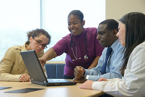 A doctor shares resources with her colleagues.