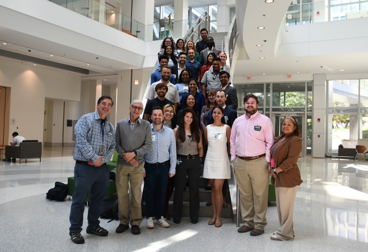 Attendees of the Biophysics Fellows Research Conference at the NIH standing on a staircase in an atrium.