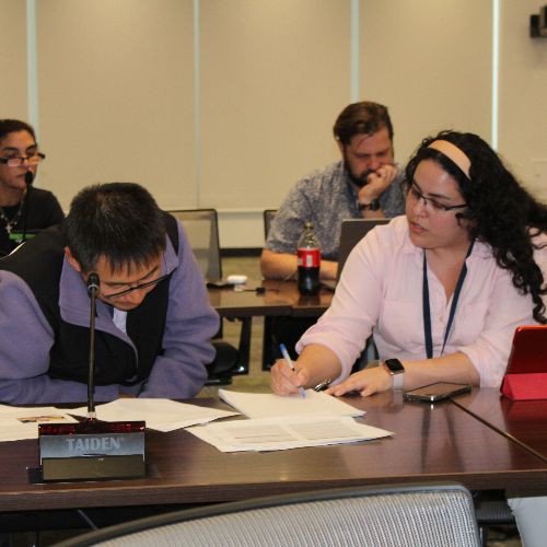 Fellows reading and writing on a desk.