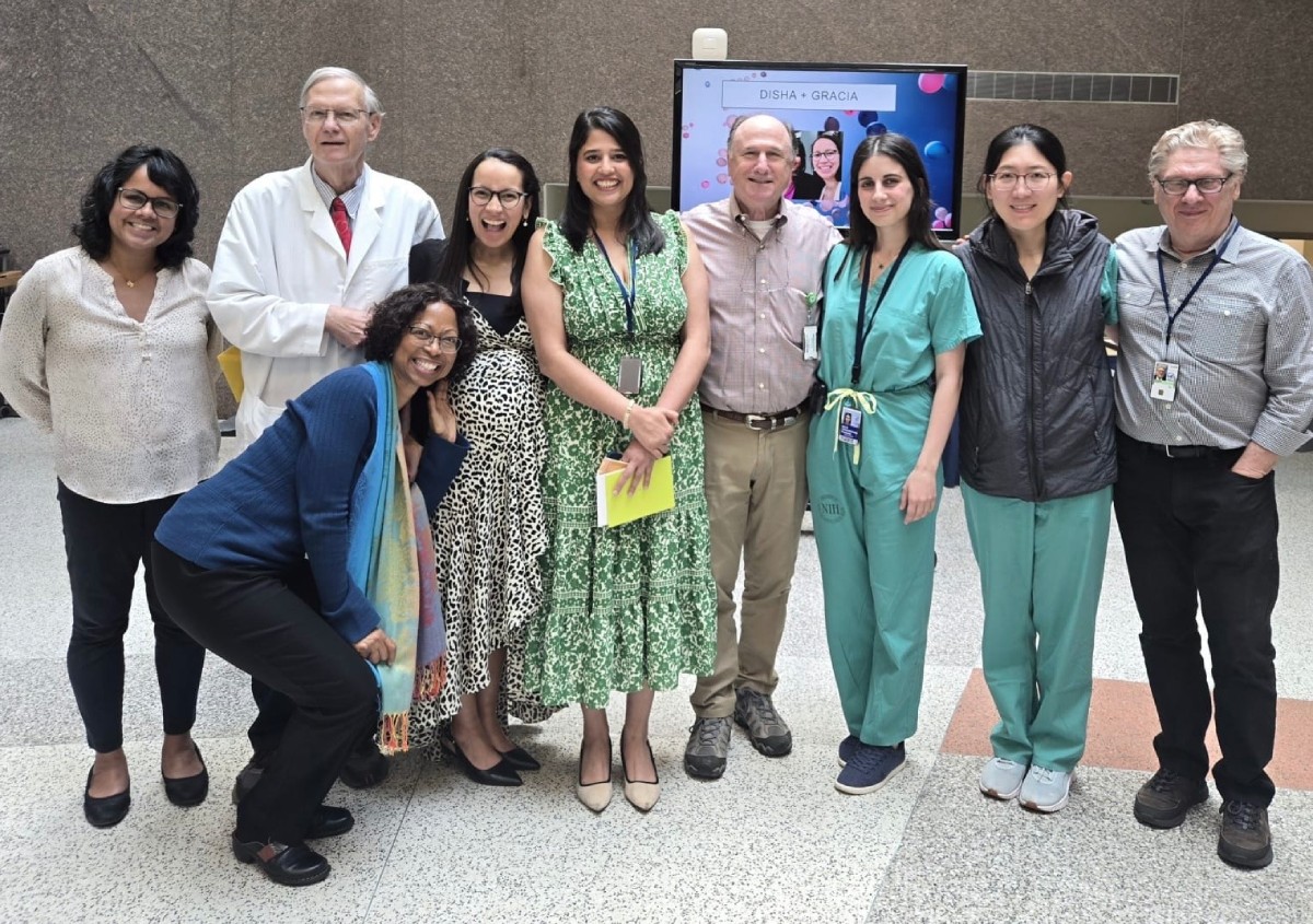 Fellows standing together and smiling at a graduation event.