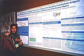 Photo of Rina Saksena explaining her poster to Dr. Tan Feizi