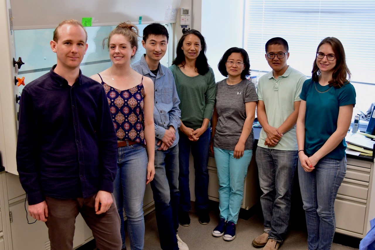 Natural Products Chemistry Section lab members standing and smiling.