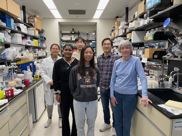 Gene Regulation and Development Section Lab Members standing in a lab.