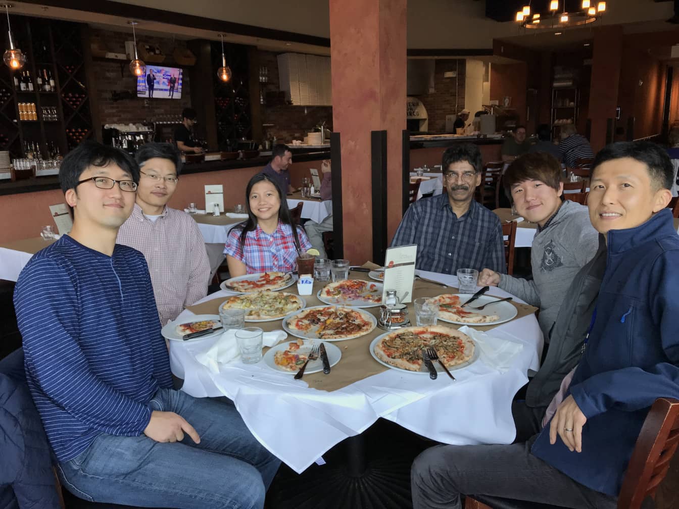 Members of the lab eat lunch around a table.