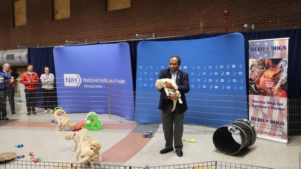 Dr. Griffin Rodgers holding a golden puppy